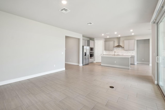 unfurnished living room with sink