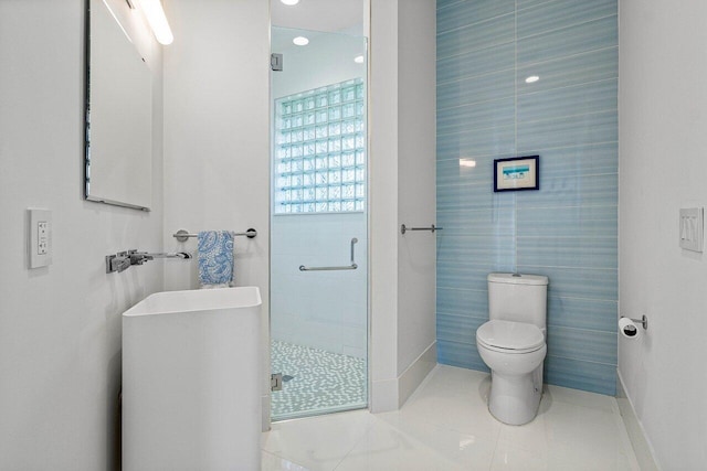 bathroom with toilet, an enclosed shower, and tile patterned floors