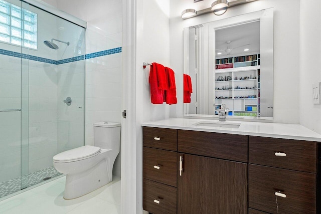 bathroom with toilet, tile patterned floors, a shower with shower door, and vanity