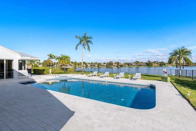 view of swimming pool featuring a patio, a yard, and a water view