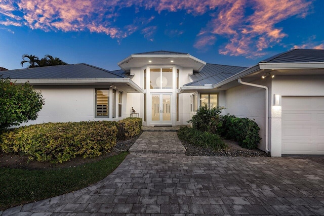 exterior entry at dusk with a garage