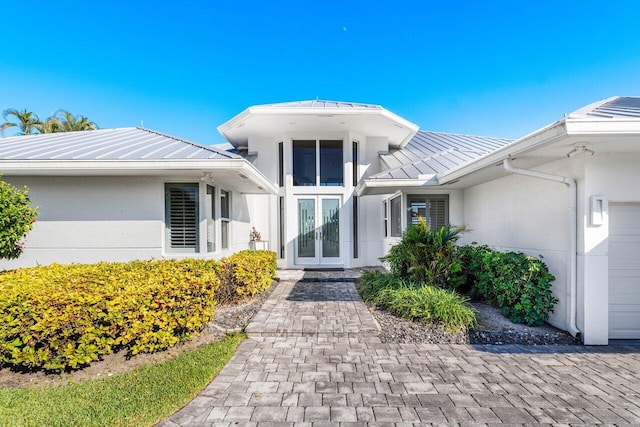 doorway to property featuring french doors and a garage