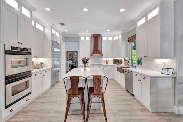 kitchen featuring a center island, white cabinets, and stainless steel appliances