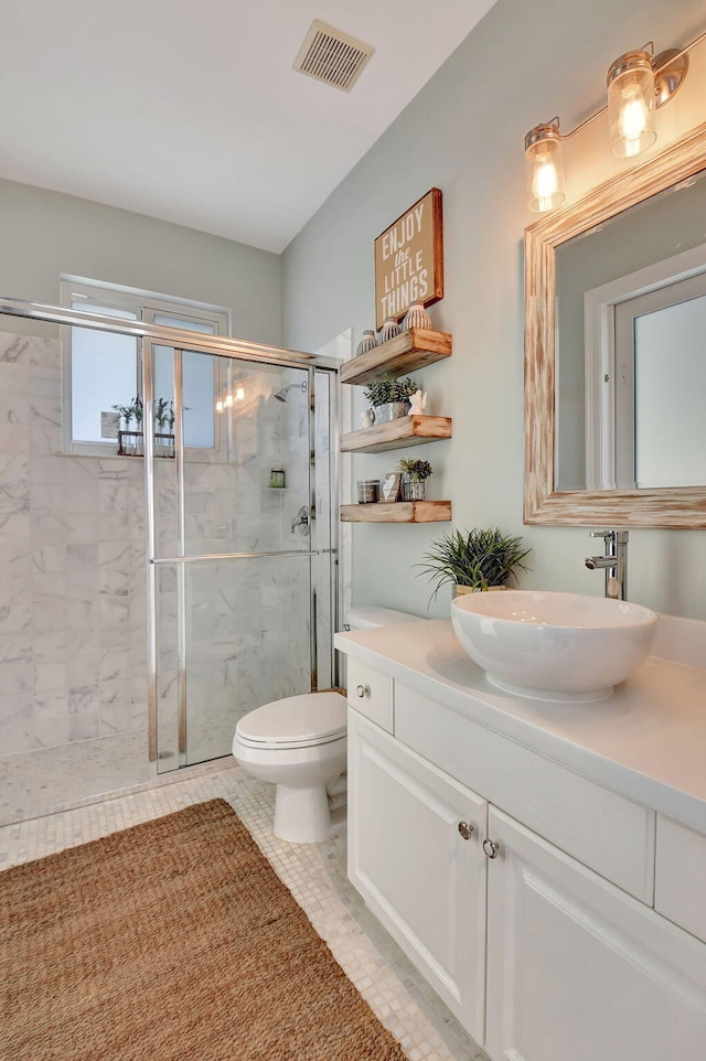 bathroom featuring toilet, vanity, tile patterned floors, and walk in shower