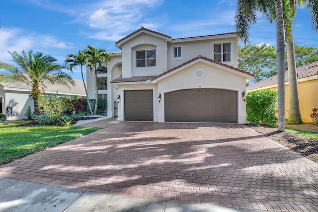 mediterranean / spanish-style house with a front yard and a garage