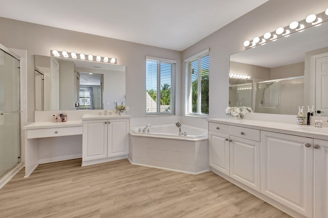 bathroom featuring wood-type flooring, vanity, and independent shower and bath