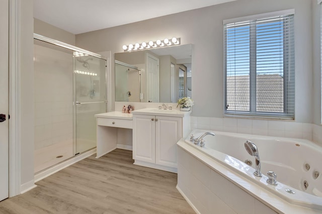 bathroom featuring vanity, plus walk in shower, and hardwood / wood-style flooring