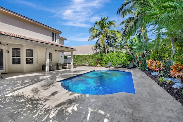 view of swimming pool featuring ceiling fan, a patio, and an outdoor hangout area