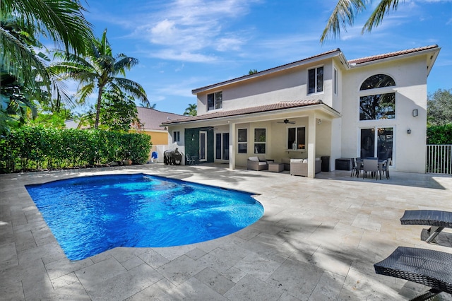 view of pool with ceiling fan and a patio area