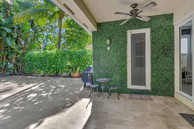 view of patio featuring ceiling fan