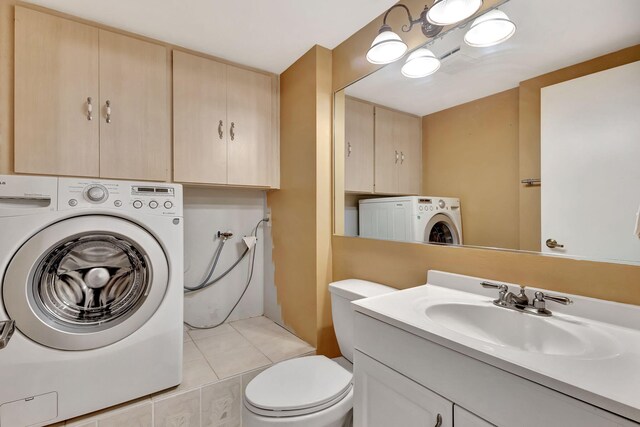 18 Amherst Ct Unit B, Royal Palm Beach, FL 33411 - bathroom featuring washer / clothes dryer, vanity, toilet, and tile patterned flooring