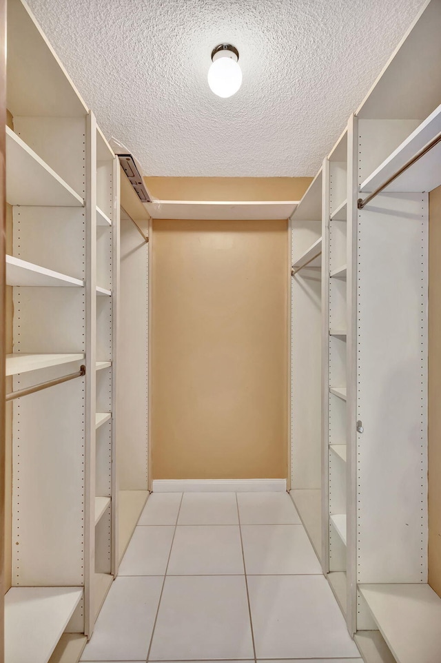 walk in closet featuring light tile patterned flooring