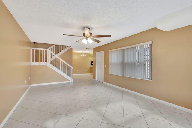 18 Amherst Ct Unit B, Royal Palm Beach, FL 33411 - tiled empty room featuring ceiling fan, baseboards, and a textured ceiling