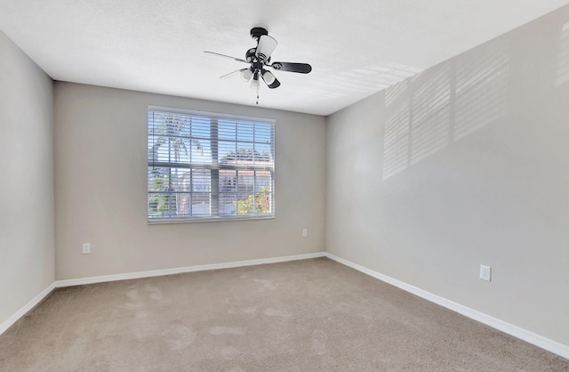 unfurnished room with ceiling fan and carpet floors