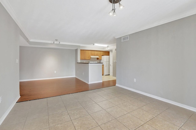 unfurnished living room featuring light tile patterned floors and crown molding