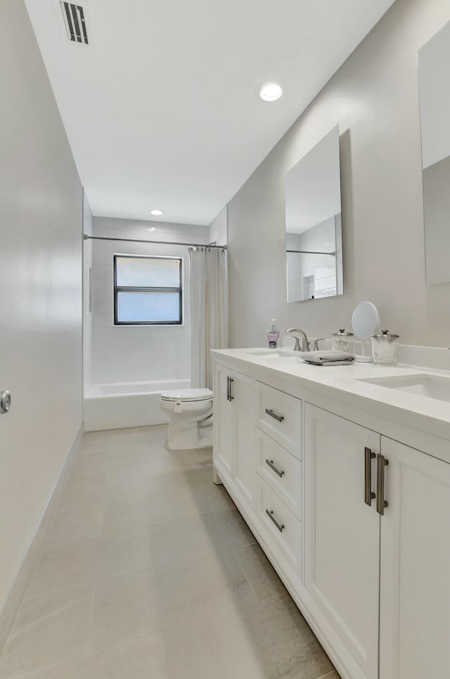 full bathroom featuring vanity, shower / bath combo, and toilet