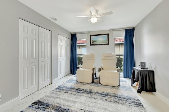 sitting room with ceiling fan and light tile patterned floors