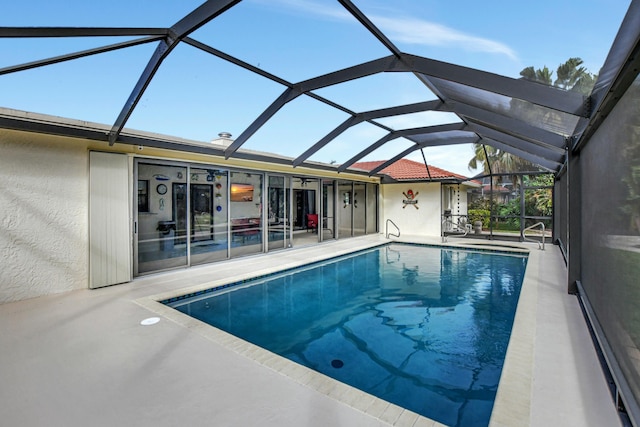 view of pool featuring a patio and glass enclosure