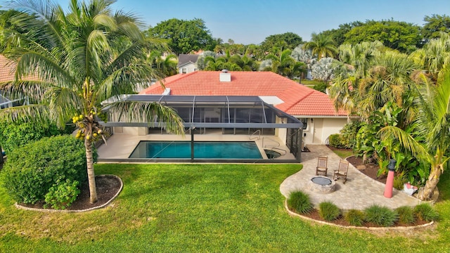 rear view of property with a lawn, a lanai, and a patio