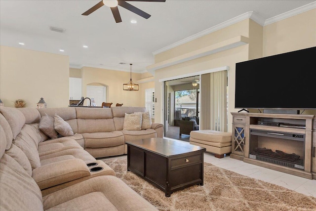 living room with ornamental molding and a chandelier