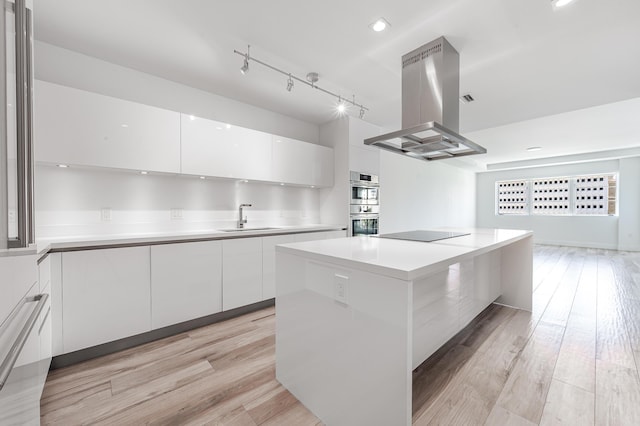 kitchen featuring white cabinetry, a center island, sink, double oven, and island exhaust hood