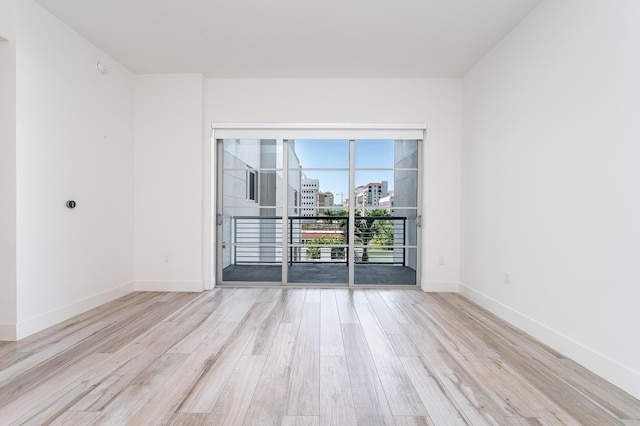 spare room with light wood-type flooring