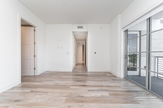 spare room with light hardwood / wood-style flooring