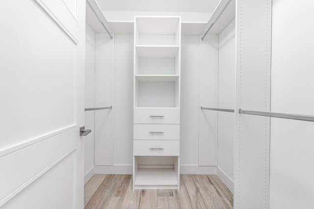 walk in closet featuring light hardwood / wood-style flooring