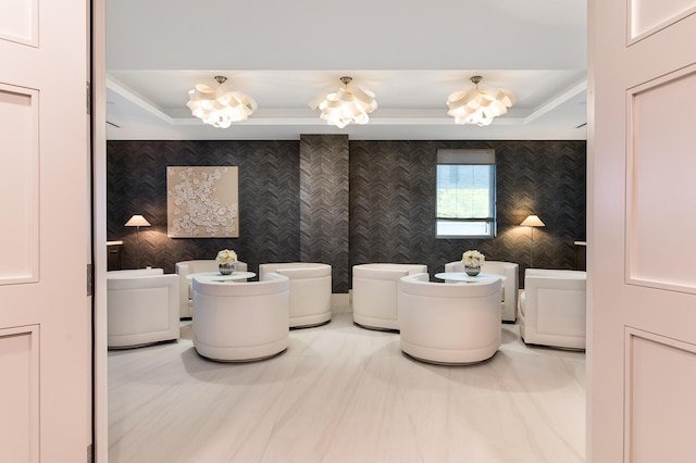 bathroom with a tray ceiling, washer and dryer, and an inviting chandelier