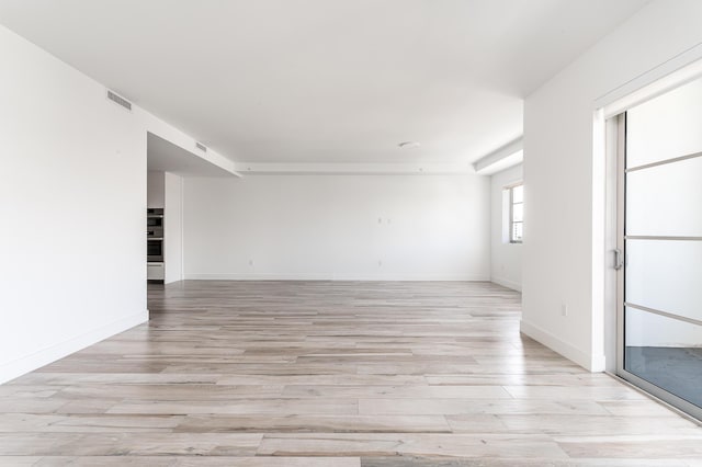 unfurnished room featuring light hardwood / wood-style floors