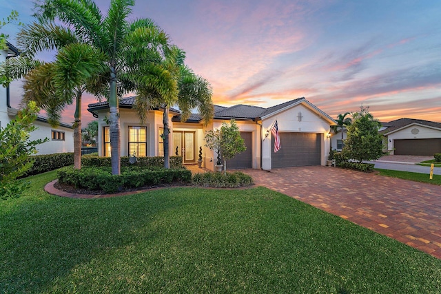 view of front of property featuring a yard and a garage