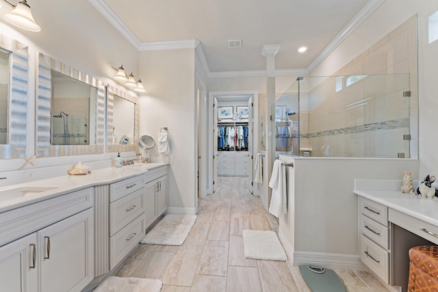 bathroom featuring vanity, a shower with door, and crown molding