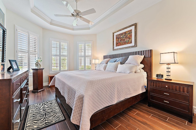 bedroom with a raised ceiling, ceiling fan, and ornamental molding