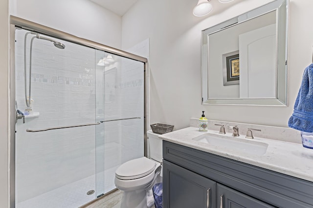 bathroom with vanity, toilet, and walk in shower