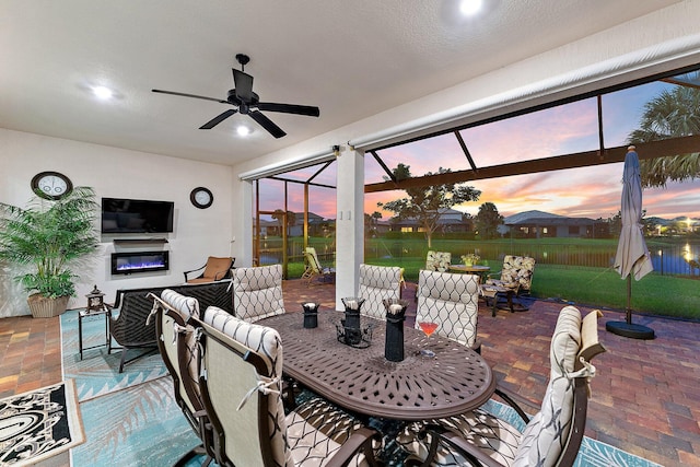 patio terrace at dusk featuring ceiling fan