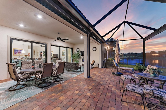 view of patio / terrace featuring ceiling fan and a lanai