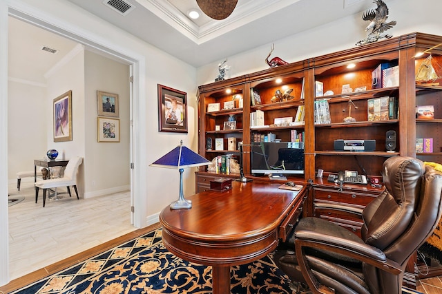 office featuring a raised ceiling, light hardwood / wood-style floors, and ornamental molding