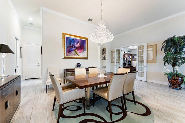 dining space featuring crown molding, french doors, and a chandelier