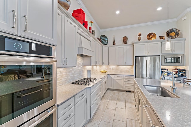 kitchen featuring sink, decorative backsplash, ornamental molding, light stone counters, and stainless steel appliances