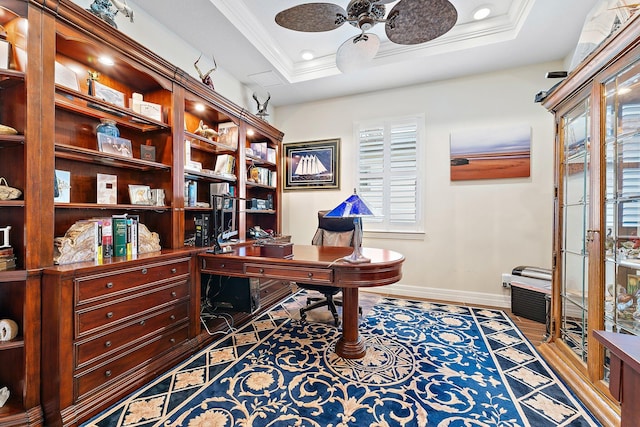 home office featuring a tray ceiling, crown molding, hardwood / wood-style floors, and ceiling fan