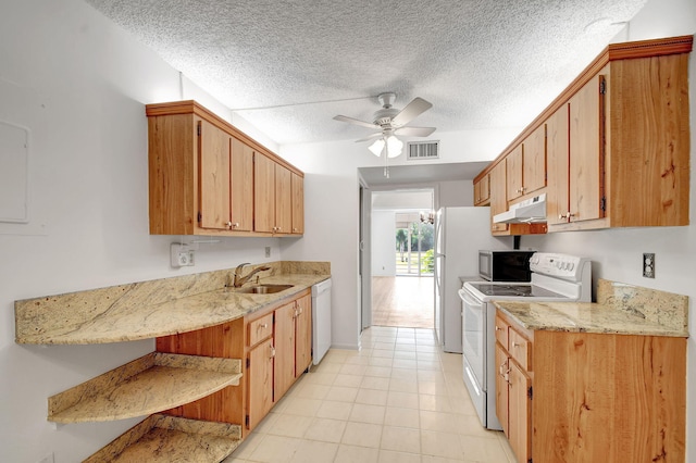 kitchen featuring a textured ceiling, white appliances, ceiling fan, and sink