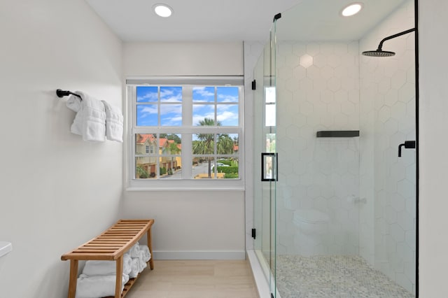 bathroom featuring a shower with door and wood-type flooring