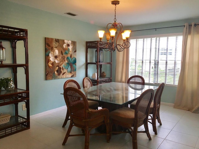 dining room featuring light tile patterned floors, an inviting chandelier, and plenty of natural light