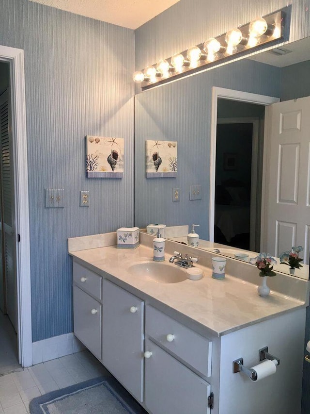 bathroom with tile patterned floors and vanity