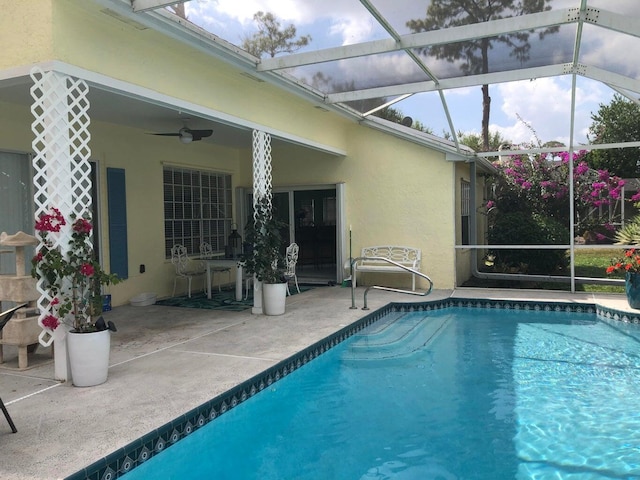 view of pool with a patio, ceiling fan, and a lanai