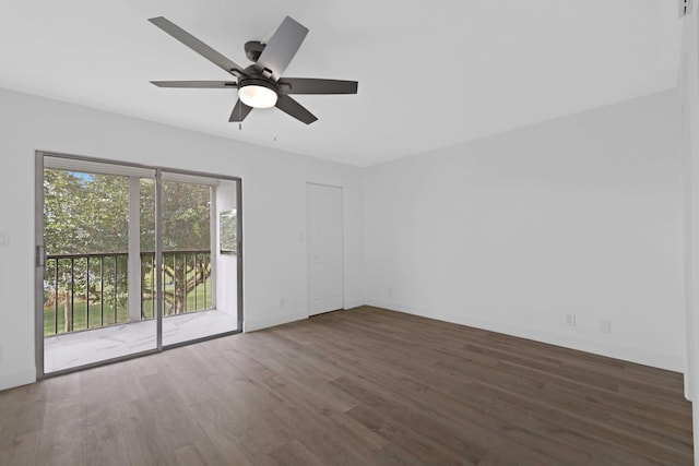 unfurnished room featuring ceiling fan and dark wood-type flooring