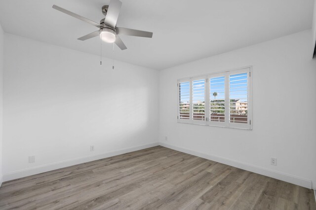 empty room featuring ceiling fan and light hardwood / wood-style flooring