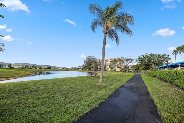 view of community with a yard and a water view