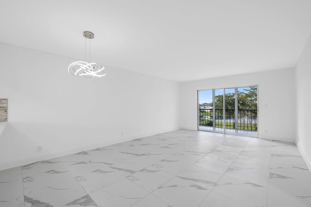 empty room featuring a chandelier