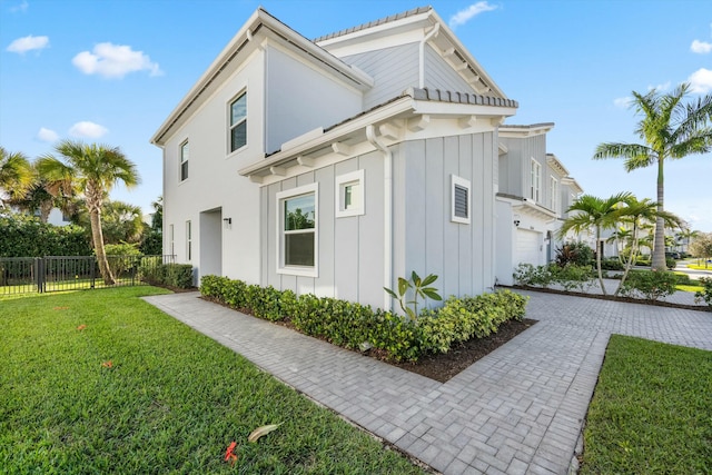 view of property exterior with a lawn and a garage